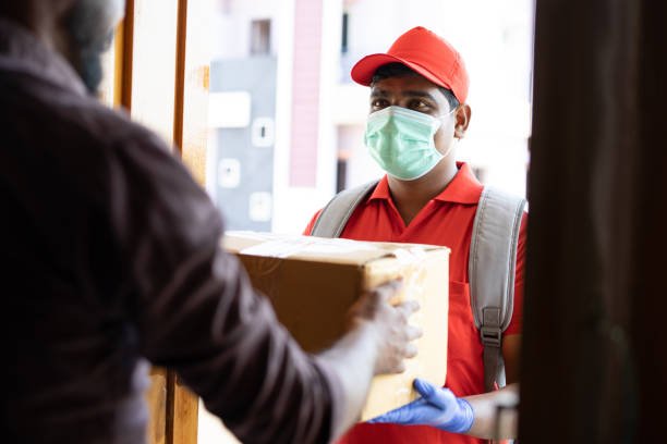A delivery person handing over a package at a patient’s door